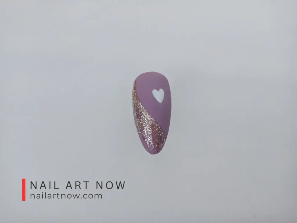 Elegant nail art design with a purple base, gold glitter, and white heart accent.