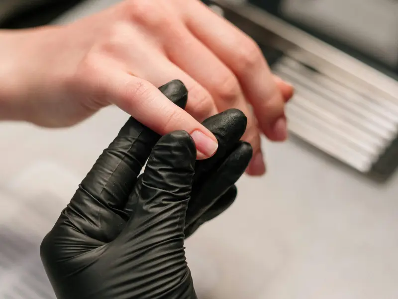 Hand gently massaging nails and cuticles for better growth.